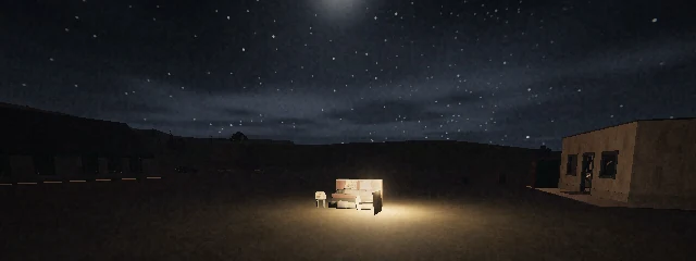 Night over an empty field: one lit table and its chairs under the stars, a low building off to the right.